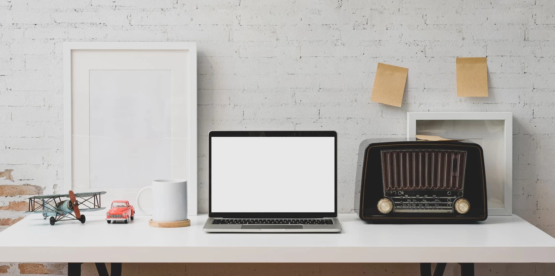 Minimal home workspace with exposed brick wall and wooden desk