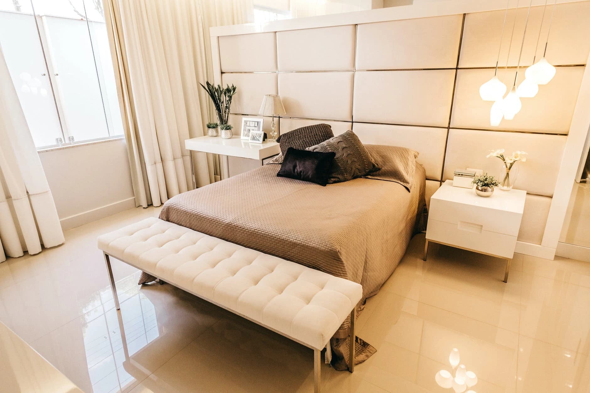 Calm bedroom with warm neutral bedding and soft furnishings