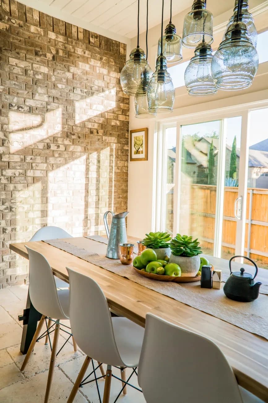 Warm dining space with wood furniture and pendant lighting
