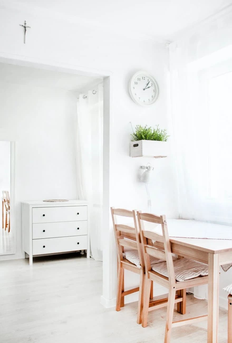 Bright compact apartment with natural wood furniture and a dining area